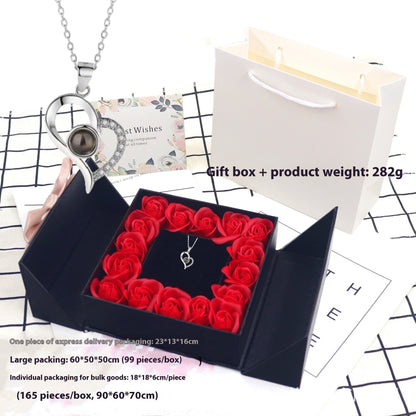 Full gift set styled flat-lay with rose box, necklace, and chain